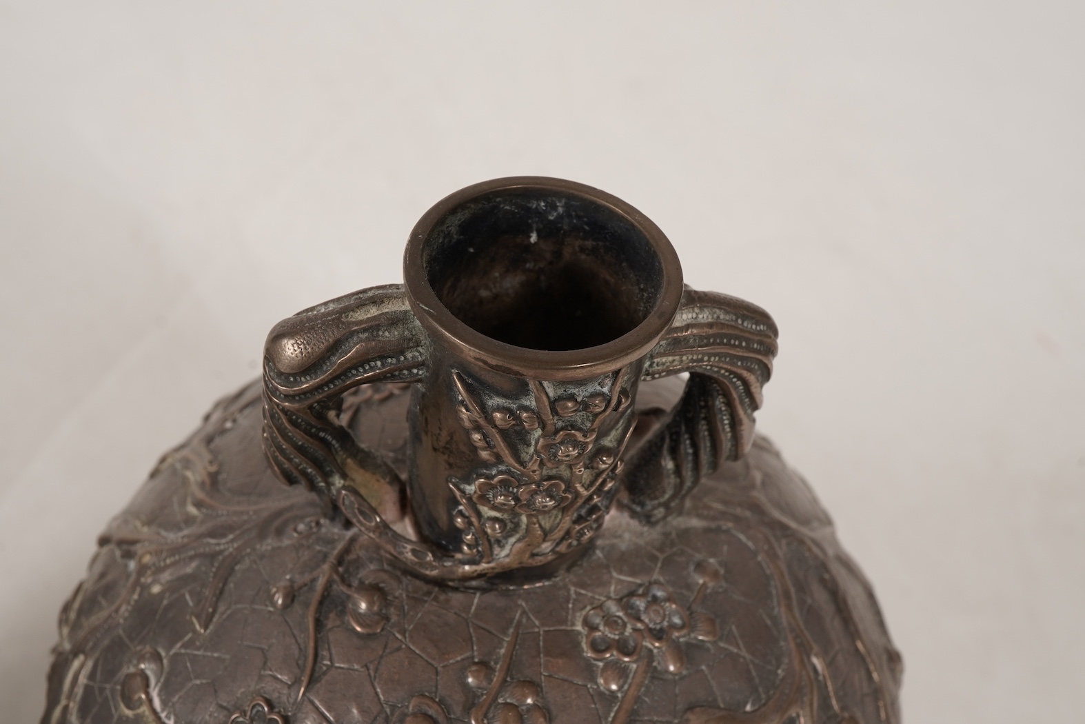 A pair of late 19th/early 20th century Chinese Export white metal two handled globular vases, by Wang Hing, Hong Kong